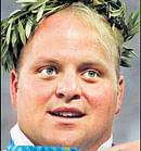 ALL SMILES In this August 20, 2004 photo, US shot putter Adam Nelson poses on the podium after winning the silver medal at the Athens Olympics. AP