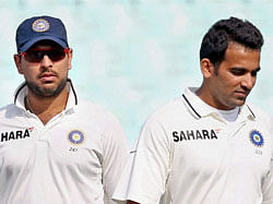 India's Yuvraj Singh, Zaheer Khan reacts after they lost 3rd Test match against England at Eden Garden in Kolkata on Sunday. PTI