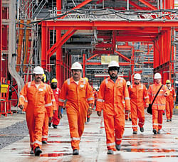 Workers walk at D Island, the main processing hub for the Kashagan oil project, in the northern Caspian Sea. Kashagan field in Kazakhstan, the worlds largest oilfield discovery in four decades - which could boost its output by about 16 percent within a year.  REUTERS