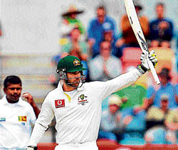 back with a bang Australias Phil Hughes raises his bat after scoring a half-century against Sri Lanka in Hobart. AP