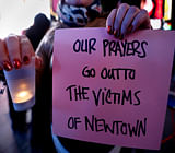 People take part in a candlelight vigil in Times Square, for the victims of the Sandy Hook School shooting, in New York, December 14, 2012. A heavily armed gunman opened fire on school children and staff at a Connecticut elementary school on Friday, killing at least 26 people, including 20 children, in the latest in a series of shooting rampages that have tormented the United States this year. REUTERS photo