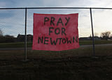 A handwritten sign reads 'Pray for Newtown' following the mass shooting at Sandy Hook Elementary School December 15, 2012 in Newtown, Connecticut. Twenty six people were shot dead, including twenty children, after a gunman identified as Adam Lanza opened fire in the school. Lanza also reportedly had committed suicide at the scene. A 28th person, believed to be Nancy Lanza was found dead in a house in town, was also believed to have been shot by Adam Lanza.  AFP photo
