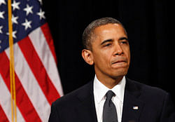 U.S. President Barack Obama looks down as he walks from the rostrum after speaking at a vigil held at Newtown High School for families of victims of the Sandy Hook Elementary School shooting in Newtown, Connecticut December 16, 2012. Obama on Sunday consoled the Connecticut town shattered by the massacre of 20 young schoolchildren, lauding residents' courage in the face of tragedy and saying the United States was not doing enough to protect its children. REUTERS