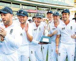 English cricketers celebrate with their spoils after claiming the four-Test series 2-1 with a draw in the final Test in Nagpur on Monday. PTI
