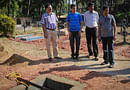 Jacintha Saldanha's widower Ben Barboza (2nd L) looks at preparations for the funeral of his wife at a cemetery in Shirva, about 52 km north of Mangalore December 17, 2012. The body of Jacintha Saldanha, the nurse who committed suicide in London after a prank call by two Australian radio presenters, will be buried on Monday, according to family members. REUTERS