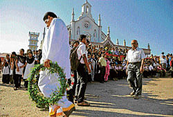 Tribute: A mourner carries a wreath to nurse Jacintha Saldanha's funeral at the Shirva Church. AFP