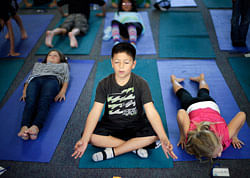 In this Dec. 11, 2012 picture, fourth grader Miguel Ruvalcaba holds a pose during a yoga class at Capri Elementary School in Encinitas, Calif. Administrators of the Encinitas Union School District are treading softly as they pioneer what is believed to be the first district-wide yoga program of its kind, while trying to avoid a legal dispute over whether yoga is just exercise or an intrinsically spiritual practice. (AP
