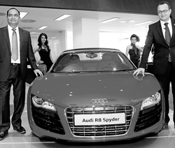 Audi India chief  Michael Perschke (right) and Audi Ahmedabad Managing  Director Samir Mistry pose next to an Audi R8 Spyder during the launch of an Audi showroom in Ahmedabad. PTI