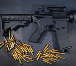 A Rock River Arms AR-15 rifle is seen with ammunition on December 18, 2012 in Miami, Florida. The weapon is similar in style to the Bushmaster AR-15 rifle that was used during a massacre at an elementary school in Newtown, Connecticut. AFP Imaget