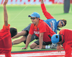 STRETCHING OUT: Gautam Gambhir leads Indian cricketers through a training session in Pune on the eve of the first T20 against England. PTI