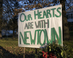 A sign is hung up across the street from the funeral home during the wake of school principal Dawn Hochsprung, a victim in the Sandy Hook Elementary School shooting, in Woodbury, Connecticut, December 19, 2012. Reuters