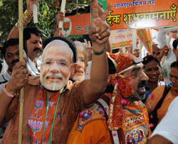 BJP workers celebrate their victory in Gujarat assembly elections, at the party office in Mumbai on Thursday. PTI