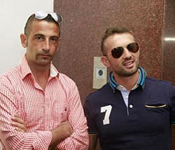 Italian sailors Massimiliano Latorre (L) and Salvatore Girone wait to board an elevator to reach the police commissioner's office in Kochi December 18, 2012.  Credit: Reuters/