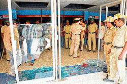 Police stand guard at Sangam theatre in Mysore on Thursday where fans of actor&#8200;Puneeth broke the glass panes. dh photo