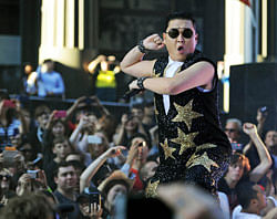In a file picture taken on October 17, 2012, South Korean pop sensation Psy, whose real name is Park Jae-Sang, performs for fans at a promotion by the Sunrise breakfast television show in central Sydney. Psy's 'Gangnam Style' video was galloping towards the one-billion-view mark on YouTube on December 21, 2012, a fresh milestone in the enduring global craze for the South Korean rapper and his horse-riding dance. AFP PHOTO