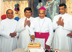 Mangalore Diocese Bishop Dr Aloysius Paul DSouza cuts a cake to mark the Christmas celebration at Bishops House in Mangalore on Friday.