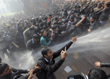 Demonstrators shout slogans as police use water cannons to disperse them near the presidential palace during a protest rally in New Delhi December 22, 2012. Indian police used batons, tear gas and water cannon to turn back thousands of people marching on the presidential palace on Saturday in intensifying protests against the gang-rape of a woman on the streets and on social media. REUTERS photo