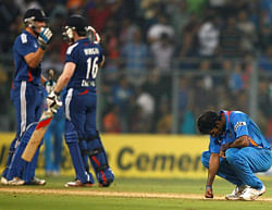 Indian bowler Ashok Dinda reacts as Eoin Morgan and Jos Buttler celebrate the victroy in the second India England T20 match in Mumbai on Saturday. PTI