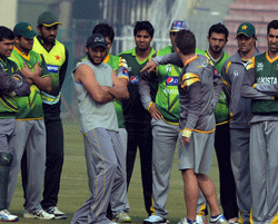 Pakistani cricketers listen to team fielding coach Julien Fountain (C) during a team practice session at the Gaddafi stadium in Lahore on December 15, 2012. Pakistan starts a week-long training camp for its landmark limited overs series against India with former captain Inzamam-ul Haq and a psychologist drafted in, an official said. AFP PHOTO