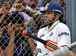 In this Thursday, Nov. 24, 2011 file photo, fans react as Indian cricket player Sachin Tendulkar arrives to bat during the third day of the third test cricket match against West Indies in Mumbai, India. India's batting great Tendulkar has announced Sunday, Dec. 23, 2012 his retirement from one-day cricket. (AP