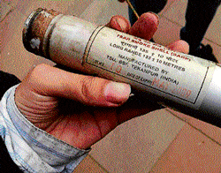 A protester shows the expired tear gas shell fired by police on Sunday.