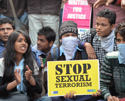 Indian demonstrators hold placards as they shout anti-government slogans during a protest calling for better safety for women following the rape of a student in New Delhi on December 24, 2012. Indian Prime Minister Manmohan Singh has appealed for calm and vowed to protect women as police stuggled to quell increasing outragte over sex crime following the gage-rape of student. AFP PHOTO
