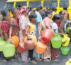 A daily ritual: Women and children lining up to collect water from tankers has become a common sight in a  majority of areas in Bangalore. DH Photo