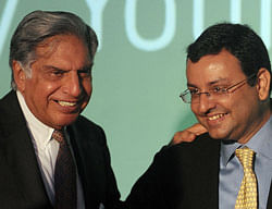 In this file photograph taken on April 23, 2012, Tata Sons chairman Ratan Tata (L) interacts with deputy chairman of Tata Sons, Cyrus Mistry (R), during a function to launch the new Croma e-retail store in Mumbai. India's head of the sprawling Tata Group empire, industrialist Ratan Tata retires on December 28, 2012 -- his 75th birthday -- while quietly handing over reins to a younger successor, Cyrus Pallonji Mistry. AFP PHOTO