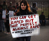 An Indian protester holds a placard during a protest against a recent gang rape of a young woman in a moving bus in New Delhi, India, Thursday, Dec. 27, 2012. Indian Prime Minister Manmohan Singh pledged Thursday to take action to protect the nation's women while the young rape victim was flown to Singapore for treatment of severe internal injuries. (AP Photo