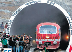 New connections : People welcome a train as it emerges from Asia's second longest tunnel during a trial run in Banihal,  Jammu and Kashmir, on Friday.  PTI