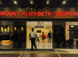 People walk through the entrance of the Mount Elizabeth hospital in Singapore, on December 29, 2012. The medical condition of an Indian gang-rape victim has 'taken a turn for the worse' with 'signs of severe organ failure', the Singapore hospital treating her said in a statement issued late on December 28, 2012. AFP PHOTO