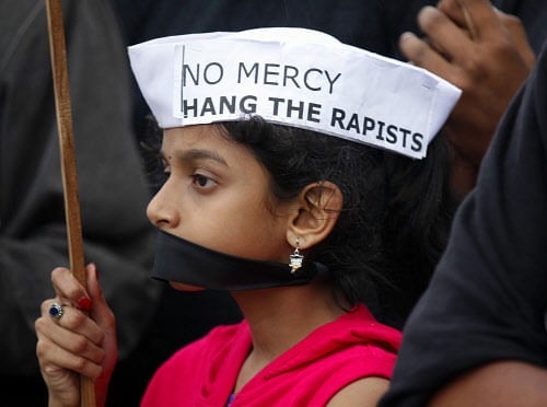 A girl participates in a protest to mourn the death of a gang rape victim, in Bangalore, India , Saturday, Dec. 29, 2012. AP