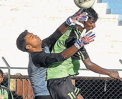 Postal goalkeeper Ravindran thwarts an attempt by South Uniteds Stephen. DH PHOTO