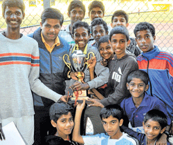 Delighted bunch: St Josephs Indian High School team members, who won the boys overall title, pose with the trophy at the Sree Kanteerava Stadium on Sunday.  dh photo