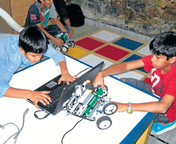 Students learn different aspects of Robotics at Winter Robotics Camp (above and below).