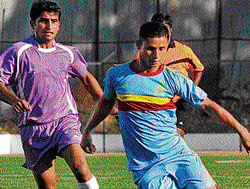 SURGING AHEAD: Nitesh of ASC (right) moves past Karthik M Of KSP during their Super Division tie on Monday. DH PHOTO