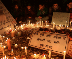 New Delhi : Girls take part in a candle light vigil for the 23-yr-old gang-rape victim at Jantar Mantar in New Delhi on the New Year eve on Monday. PTI Photo
