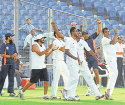 A jubilant Karnataka team celebrate their victory over Maharashtra that powered them into the quarterfinals.