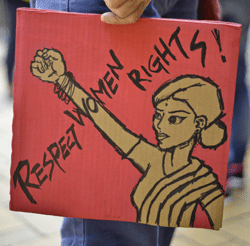 A participant holds a placard during an 'anti-violence towards women' march below the Indian consulate in Hong Kong on January 1, 2013 after the death of an Indian gang rape victim. The family of an Indian gang-rape victim said on December 31 they would not rest until her killers are hanged as police finalised their investigation before charges are laid against suspects this week. AFP PHOTO