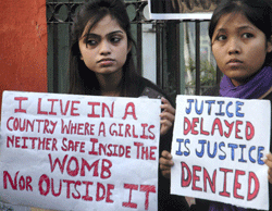 Young girls display placards during a demonstration demanding justice for the rape victim. PTI Image