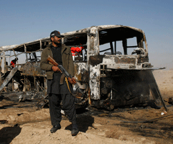 A paramilitary soldier stands guard at the site of a bomb explosion in Quetta December 30, 2012. The car bomb exploded on Sunday near a convoy of buses taking Pakistani Shia pilgrims to Iran, killing 20 people and wounding 24, officials said, the latest attack on the minority sect. REUTERS