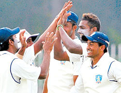 A Mithun (second from right) bowled his heart out on an unresponsive pitch against Saurashtra. File photo