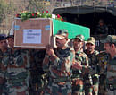 Rajouri: Army soldiers carry a coffin containing the body of a colleague who was allegedly killed by Pakistani soldiers at Rajouri on Wednesday. PTI Photo