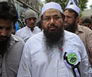 Hafiz Saeed (C), the head of Jamaat-ud-Dawa organisation and founder of Lashkar-e-Taiba, arrives to take part in a protest rally in Lahore July 8, 2012.