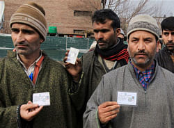 Panchs and Sarpanches from Sopore holding their identity cards as they announce their resignation in Srinagar on Sunday. They resigned following the attacks on two Panchayat members in Sopore in last two days. PTI
