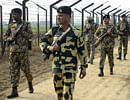 Indian Border Security Force soldiers patrol along the India-Pakistan border fence about 27 KM from Wagah on January 13, 2013. Two Indian soldiers died after a firefight erupted in disputed Kashmir on January 8, 2012 as a patrol moving in fog discovered Pakistani troops about 500 metres (yards) inside Indian territory, according to the Indian army. AFP PHOTO