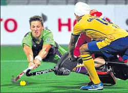 CHILDS PLAY: Delhi Waveriders Simon Child (left) vies for the ball with Punjab Warriors players in the opening match of the Hockey India League in New Delhi on Monday. PTI