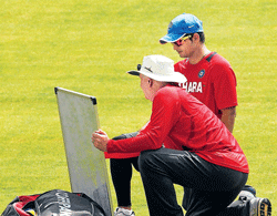 its done like this son: Indias coach Duncan Fletcher explains a point to Suresh Raina on Monday. PTI