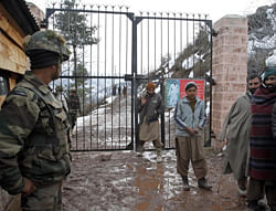 An Indian army soldier stands guard as villagers cross a gate that leads to the Line of Control (LOC), the line that divides Kashmir between India and Pakistan, in Churunda village, about 150 Kilometers (94 miles) northwest of Srinagar, India, Tuesday, Jan. 15, 2013. India's relations with archrival Pakistan 'cannot be business as usual' in the wake of a spate of attacks in Kashmir, Prime Minister Manmohan Singh said Tuesday in a statement that threatens to ratchet up tensions in the wake of the Himalayan violence. A series of tit-for-tat attacks, including the beheading of an Indian soldier, across the LOC that divides the Himalayan region has killed two Pakistani and two Indian soldiers over the past 10 days. Poster seen on gate warns civilians of land mines on the other side of the gate. AP