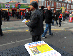 Santanu Pal, father of Souvik Pal, distributes leaflets appealing for information regarding the wherabouts of his son ahead of the Manchester United versus Liverpool football match in Manchester, north-west England on January 13, 2013. Pal, an 18-year-old studying at Manchester Metropolitan University in northwest England, has been missing since celebrating New Year's Eve with friends at a nightclub in the city. AFP PHOTO